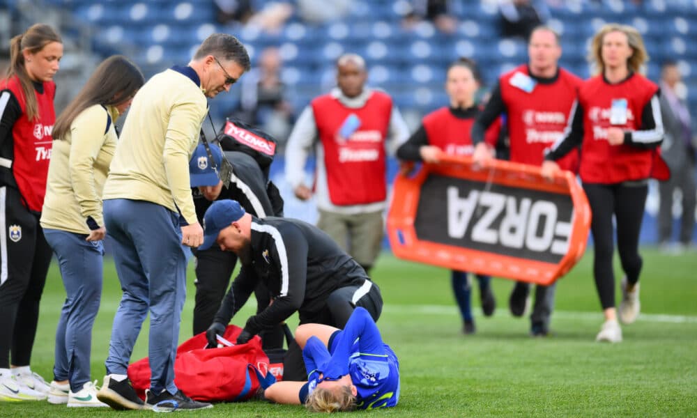 Jess Fishlock stretchered off the field in Seattle